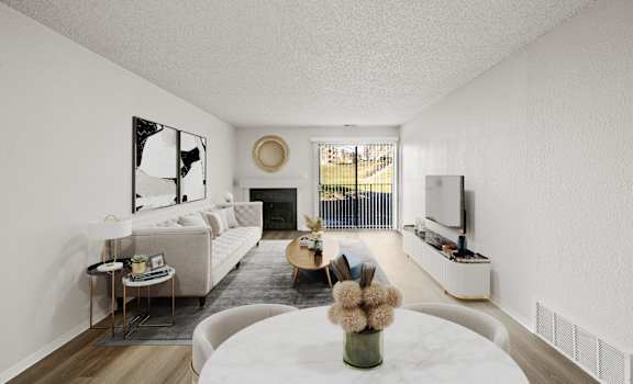A modern living room with a fireplace and a large mirror on the wall.