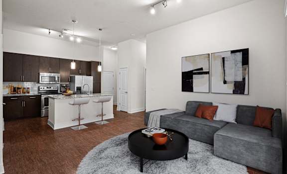 A modern living room with a grey couch and a black coffee table at West 39th Street Apartments, Kansas City, 64111