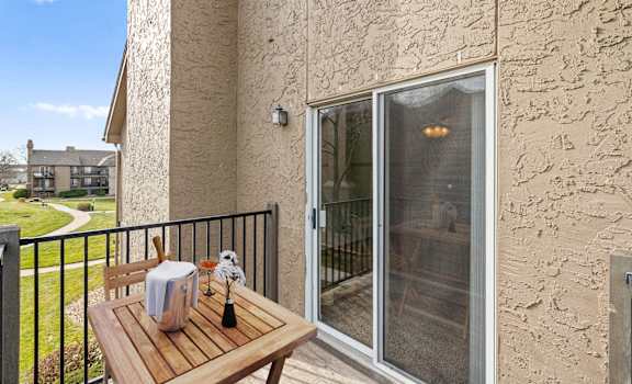 a patio with a table and a sliding glass door