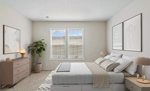 A well-lit bedroom with a large bed, a dresser, and a potted plant.