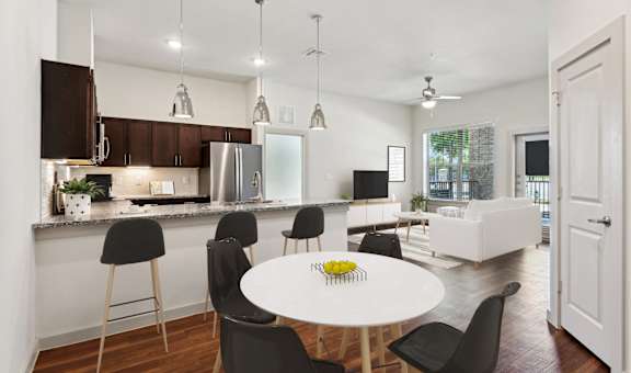a kitchen and dining room with a white table and chairs