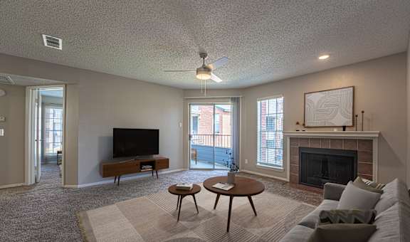 A living room with a fireplace and a television.