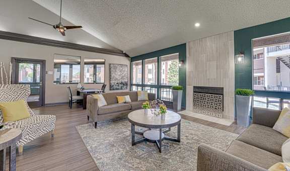 A living room with a fireplace and a ceiling fan.