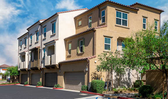 a group of apartment buildings with garages
