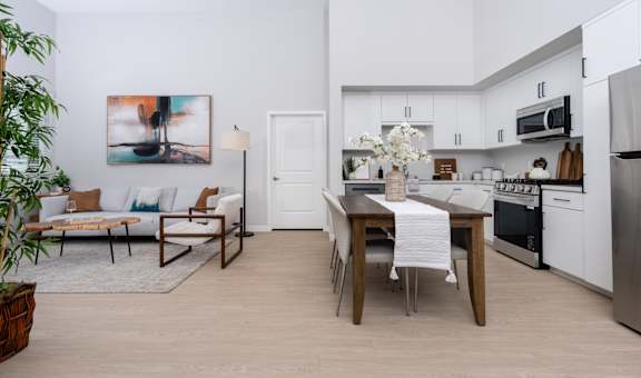A modern kitchen with a dining table and chairs.