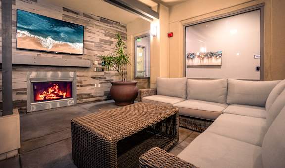A modern living room with a fireplace and a flat screen TV.