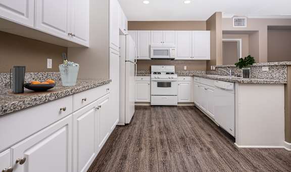 a kitchen with white cabinets and white appliances