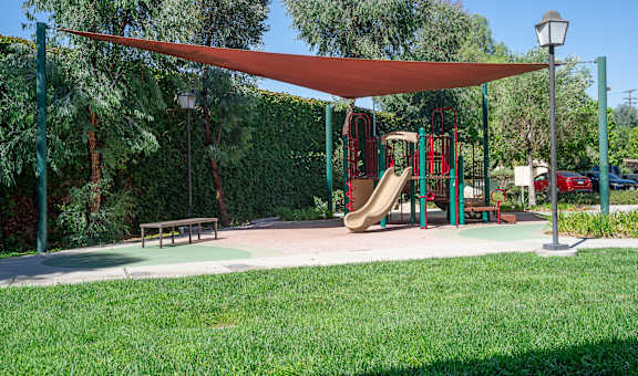 a playground with a swing set and a jungle gym