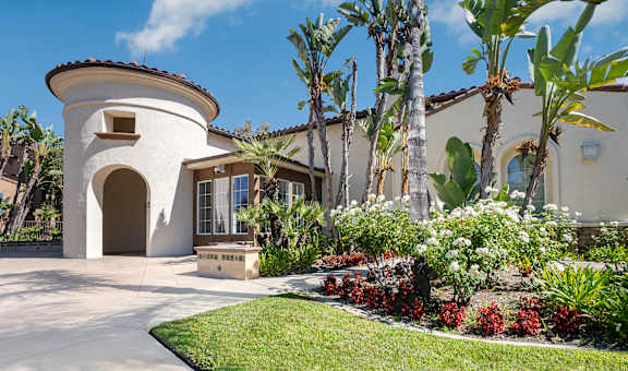 a house with palm trees in the background