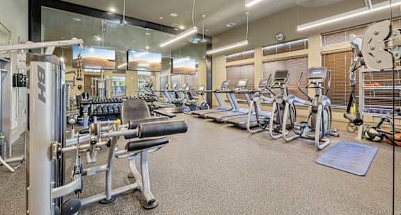 A gym with a variety of equipment including weights and cardio machines.at North Creek, Hutto, TX, 78634