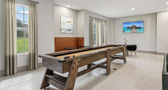 A pool table in a room with a television on the wall at La Ventura Apartments, Texas, 75093