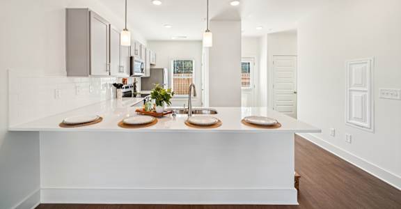 Modern kitchen with large island at Turnberry Park Apartments in Gardendale, AL