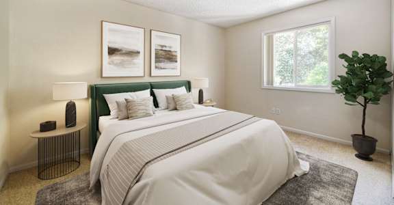 A bedroom with a large bed and a green headboard.