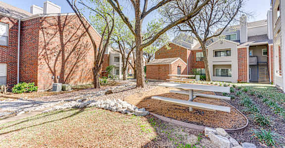 A brick building with a tree in front of it.