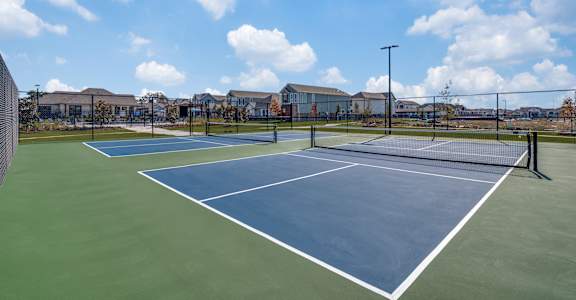 A tennis court with a blue surface and white lines.