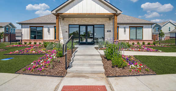A building with a front yard and a sign that says "ENTRANCE".