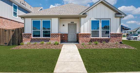 A house with a grey roof and a white door.