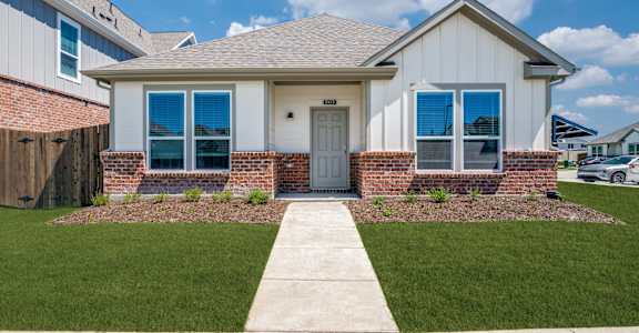 A house with a grey roof and a white door.