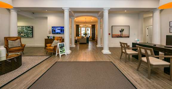 a large living room with pillars and chairs and a piano at Sunrise Canyon, Universal City, TX, 78148