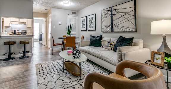 an open living room and kitchen with a couch and a table