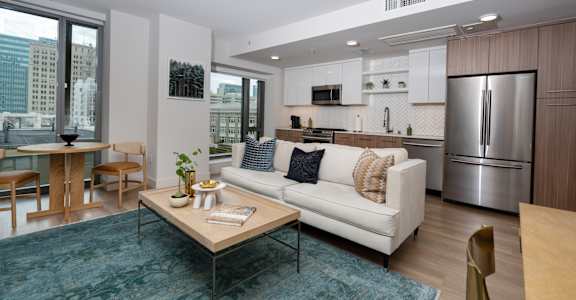 A modern living room with a white couch and a coffee table.
