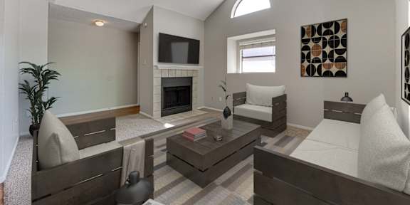 A living room with a fireplace and a television.