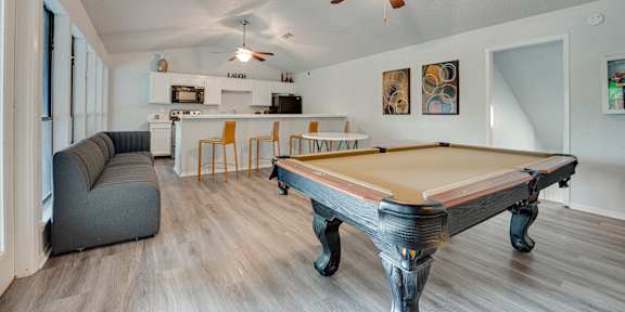 a living room with a large window and a ceiling fan at Indian Creek Apartments, Texas