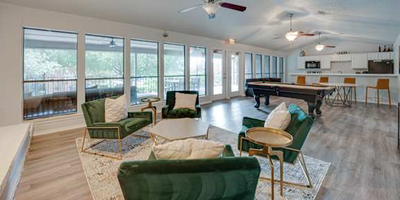 a living room with furniture and a pool table at Indian Creek Apartments, Texas