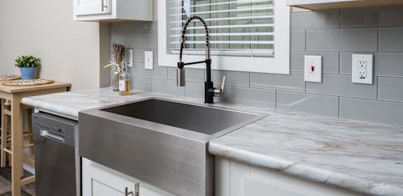 a modern kitchen with a sink and a window