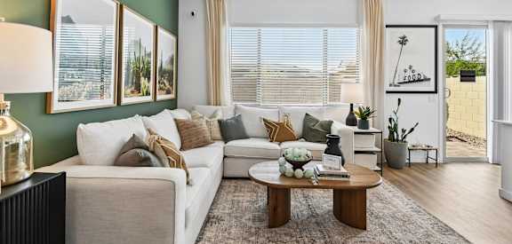 A living room with a white couch and a coffee table.