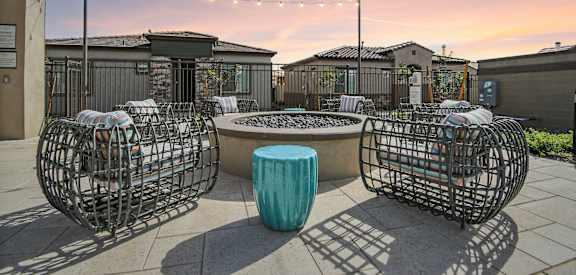 A patio with a table and chairs with a blue container in the middle.