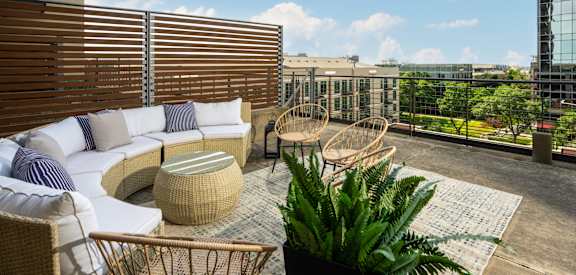 sundeck with couches and chairs at The Heights at Park Lane, Texas