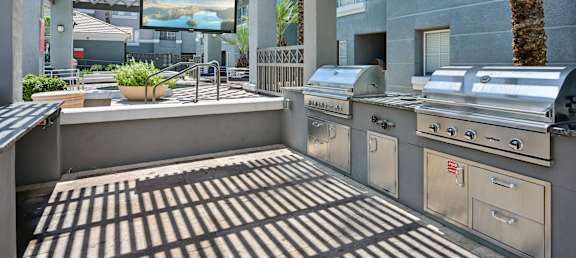 A patio with a grill and a television.
