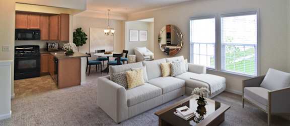 A well-lit, spacious living room with a kitchen area in the background. at Barrington Park Apartments, Virginia, 20110