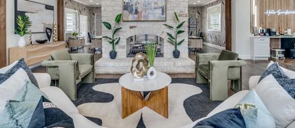 a living room with couches and chairs and a fireplace