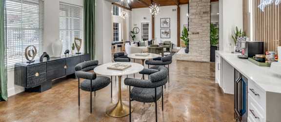 a living room with tables and chairs and a fireplace