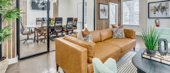 a living room with a couch and a table with chairs