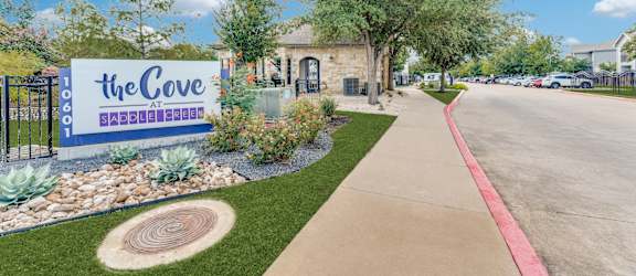 the cove leasing office sign at the entrance of the cove apartments