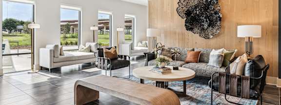 a living room with couches and chairs and a table
