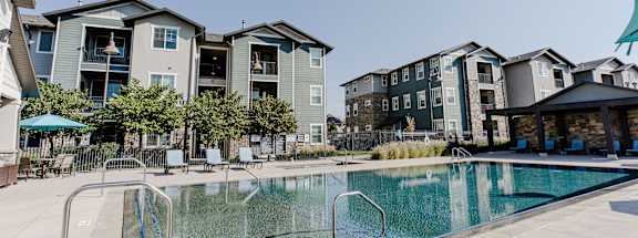 a pool at the whispering winds apartments in pearland, tx