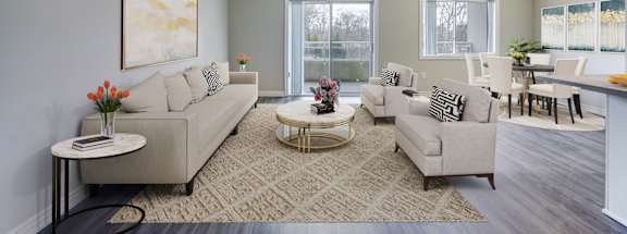 a living room with grey walls and white furniture