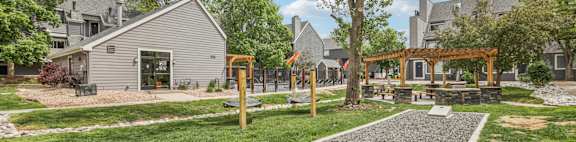 A playground with a slide and a swing set in a grassy area.