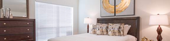 a bedroom with a ceiling fan and dresser