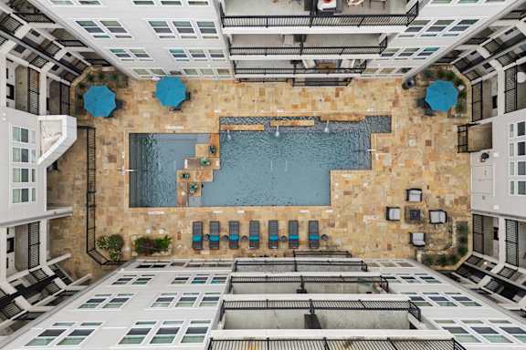 A large indoor swimming pool with a stone wall and a tiled floor.