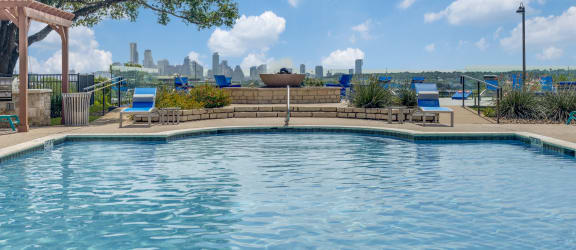 a pool with a view of the city in the background