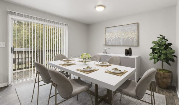 a dining room with a white table and chairs