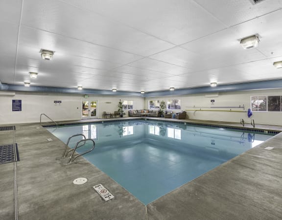 a large indoor swimming pool with a diving board