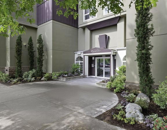 a picture of a building with a driveway in front of it at Excalibur, Bellevue, WA