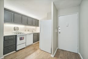 a kitchen with white appliances and gray cabinets
