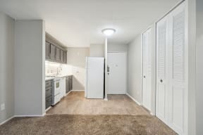 a kitchen with a white refrigerator freezer next to a white stove top oven
